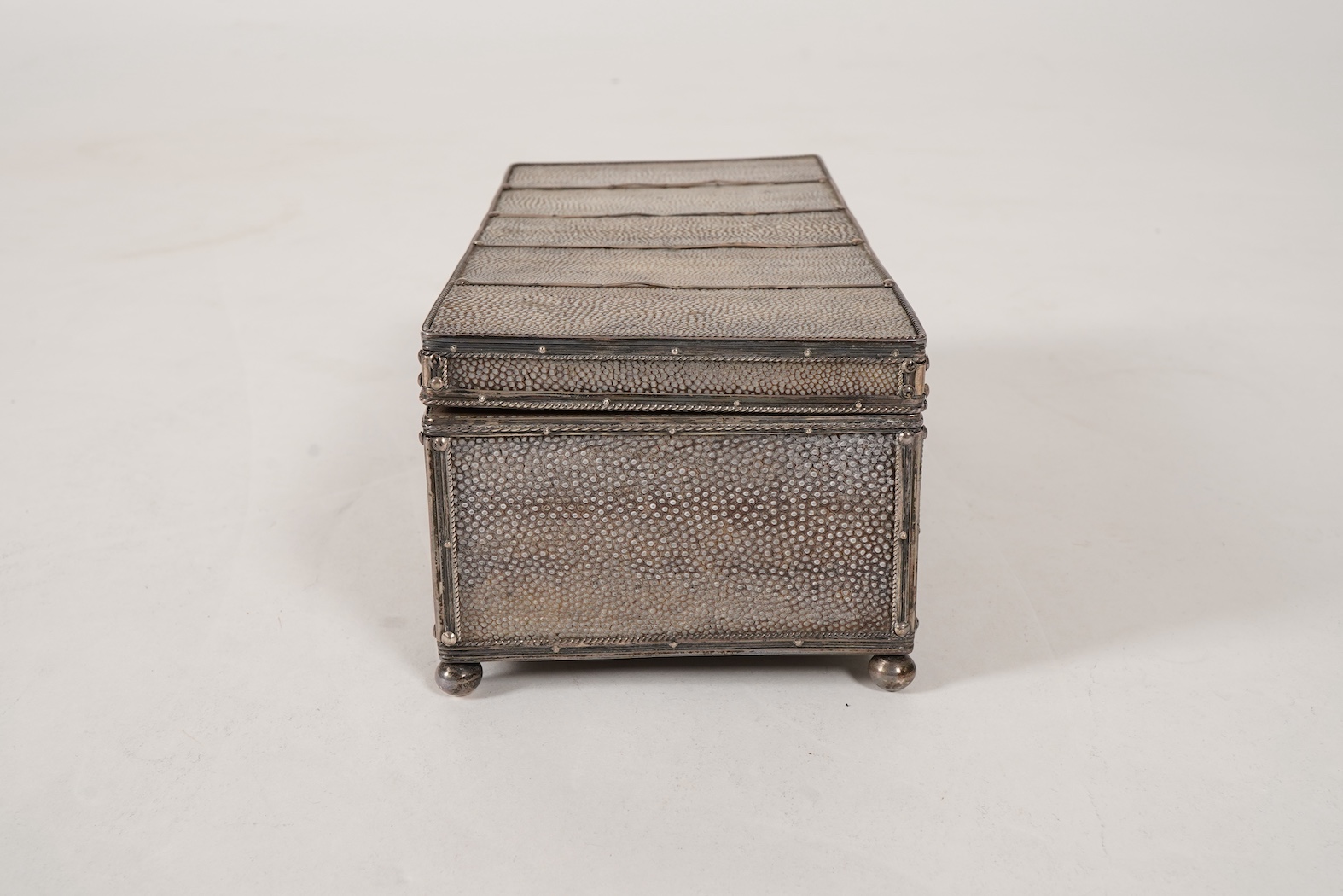 An early 20th century Arts & Crafts silver and shagreen mounted cigarette box with hinged cover, by John Paul Cooper